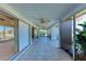 Spacious covered patio featuring tile flooring, ceiling fans, and access to the outdoors at 3259 Fairhaven Ln # 211, Sarasota, FL 34239