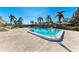 Inviting community pool area with palm trees and ample space for lounging and recreation at 3259 Fairhaven Ln # 211, Sarasota, FL 34239