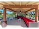 Relax under this covered poolside cabana, featuring comfortable seating and a ceiling fan to stay cool and comfortable at 3259 Fairhaven Ln # 211, Sarasota, FL 34239