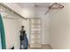 A clean walk-in closet with built in shelves and hanging rods for maximum storage at 3259 Fairhaven Ln # 211, Sarasota, FL 34239