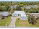 Expansive aerial view of a home featuring modern design, green lawn, and long driveway at 3319 Mayflower St, Sarasota, FL 34231