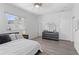 Bright bedroom features wood floors, a ceiling fan, and a dresser with a round mirror at 3319 Mayflower St, Sarasota, FL 34231