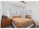 Cozy bedroom with a ceiling fan, light wood nightstand and large mirrored closet at 3319 Mayflower St, Sarasota, FL 34231
