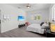 Bright bedroom with gray flooring, large windows, ceiling fan, and beach scene on mounted television at 3319 Mayflower St, Sarasota, FL 34231