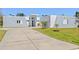 Modern, gray and white home featuring a concrete driveway and minimalist landscaping at 3319 Mayflower St, Sarasota, FL 34231