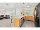 Modern kitchen featuring natural wood cabinets and views of the outdoors at 3319 Mayflower St, Sarasota, FL 34231