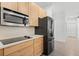 Modern kitchen with sleek countertops, wood cabinets, and stainless steel appliances at 3319 Mayflower St, Sarasota, FL 34231