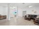 Open-concept living room with a leather couch and hardwood floors offers a versatile layout for entertaining and relaxation at 3319 Mayflower St, Sarasota, FL 34231