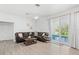 Bright living room boasts wood laminate floors and sliding glass doors opening to the pool at 3319 Mayflower St, Sarasota, FL 34231
