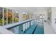 Bright and inviting indoor pool offers a refreshing retreat with ample sunlight and views of the surrounding greenery at 3319 Mayflower St, Sarasota, FL 34231