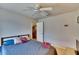 Bedroom with tiled floors and neutral walls has a ceiling fan and door leading to another room at 3514 14Th E Ct, Ellenton, FL 34222