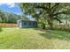 View of the backyard featuring the house and the new wooden fence at 3561 Elfers Pkwy, New Port Richey, FL 34655
