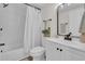 Modern bathroom featuring a shower-tub combo, updated vanity, and stylish fixtures at 3561 Elfers Pkwy, New Port Richey, FL 34655