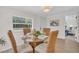 Bright dining area with modern light fixture, round glass table, and stylish woven chairs at 3561 Elfers Pkwy, New Port Richey, FL 34655