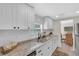 Bright kitchen featuring white cabinets, granite countertops, and stainless steel appliances at 3561 Elfers Pkwy, New Port Richey, FL 34655