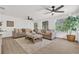 Bright and airy living room with neutral tones, plush sofas, stylish ceiling fans, and ample natural light at 3561 Elfers Pkwy, New Port Richey, FL 34655