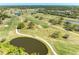 Aerial view of lush golf course with ponds, trees, and golf carts at 3717 Delta St # 95, Sarasota, FL 34232