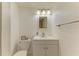 A clean, bright bathroom with a vanity, toilet, mirror, and modern lighting at 3717 Delta St # 95, Sarasota, FL 34232
