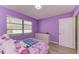Cozy bedroom features a playful theme, natural light, and light wood laminate flooring at 3717 Delta St # 95, Sarasota, FL 34232