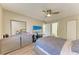 Bedroom features a ceiling fan, dresser, television and access to an ensuite bathroom at 3717 Delta St # 95, Sarasota, FL 34232