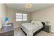 Comfortable bedroom featuring neutral walls, natural light, laminate flooring, and two nightstands at 3717 Delta St # 95, Sarasota, FL 34232