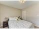 Comfortable bedroom featuring neutral walls, natural light, laminate flooring, and two nightstands at 3717 Delta St # 95, Sarasota, FL 34232