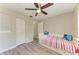 This bedroom features laminate flooring, neutral walls, and a modern ceiling fan at 3717 Delta St # 95, Sarasota, FL 34232
