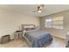 Bedroom featuring a ceiling fan, window, and stylish decor at 3717 Delta St # 95, Sarasota, FL 34232
