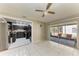 Bright dining area features tile flooring, ceiling fan, and view of the kitchen and outdoor patio at 3717 Delta St # 95, Sarasota, FL 34232