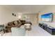 Inviting living room with tile floors, plush seating, entertainment center, and bright natural light at 3717 Delta St # 95, Sarasota, FL 34232