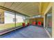 Relaxing screened patio with neutral carpet and four comfy red chairs at 3717 Delta St # 95, Sarasota, FL 34232