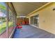 Relaxing screened patio with neutral carpet and four comfy red chairs at 3717 Delta St # 95, Sarasota, FL 34232
