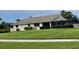 Expansive backyard features lush green lawn, an enclosed porch, and mature landscaping at 3799 Countryside Rd, Sarasota, FL 34233