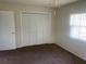 Cozy bedroom with carpeted floors, a window with blinds, and a closet providing comfortable living space at 3799 Countryside Rd, Sarasota, FL 34233