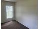 Bedroom with carpeted floors and window with blinds, providing a serene and comfortable space at 3799 Countryside Rd, Sarasota, FL 34233