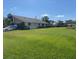 Exterior view of a well-maintained home, lush lawn and beautiful mature landscaping at 3799 Countryside Rd, Sarasota, FL 34233