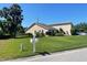 A charming single story home with a lush green lawn and mature landscaping at 3799 Countryside Rd, Sarasota, FL 34233