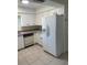 Bright kitchen featuring white cabinetry, tiled floors, and modern appliances for a functional cooking space at 3799 Countryside Rd, Sarasota, FL 34233