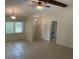 Open living room boasts tile flooring, a beamed ceiling, and a charming pendant lights at 3799 Countryside Rd, Sarasota, FL 34233