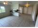 Open-concept living space features tile flooring, ceiling fan and a view into the kitchen and dining area at 3799 Countryside Rd, Sarasota, FL 34233