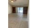 Spacious living room with tile floors, built-in bookcases, and a sliding glass door at 3799 Countryside Rd, Sarasota, FL 34233