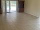 Open living room with tile floors, sliding door access to pool and view of built-in shelving at 3799 Countryside Rd, Sarasota, FL 34233