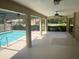 Screened-in patio view of the sparkling pool and lush backyard at 3799 Countryside Rd, Sarasota, FL 34233