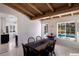 Dining room features a beamed ceiling, tile flooring, and a pool view at 426 S Shore Dr, Sarasota, FL 34234