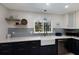 Newly renovated kitchen features a white apron sink, blue backsplash, stainless steel appliances, and modern fixtures at 426 S Shore Dr, Sarasota, FL 34234