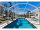 Screened-in pool with clear blue water and a view of the well-maintained backyard at 426 S Shore Dr, Sarasota, FL 34234