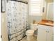 Bathroom with a white vanity, toilet, and shower featuring anchor-themed curtain at 4506 62Nd E Ter, Bradenton, FL 34203