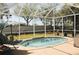 Enclosed pool and patio area with comfortable seating and backyard views at 4506 62Nd E Ter, Bradenton, FL 34203
