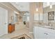 Bathroom featuring a soaking tub, walk-in shower, marble countertops, and lots of natural light from the window at 4520 Longspur Ln, Sarasota, FL 34238