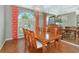 Sophisticated dining room featuring a large wooden table, chandelier lighting, and elegant window treatments at 4520 Longspur Ln, Sarasota, FL 34238